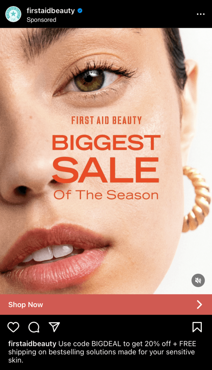 An Instagram ad from beauty brand First Aid Beauty. The static ad shows a close up image of a woman's face with text across it that promotes the brand's sale.